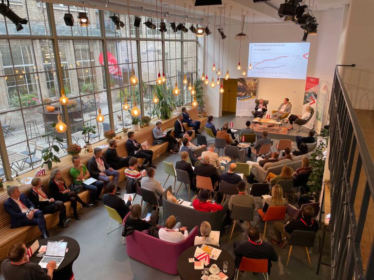 Room with people photographed from above during a presentation with a screen